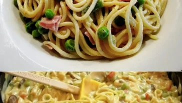 Spaghetti in einer cremigen Käse-Sahnesoße serviert auf einem Teller.