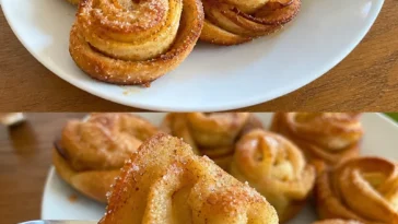 Leckere Apfelbrötchen auf einem Teller, frisch gebacken und verführerisch dekoriert.