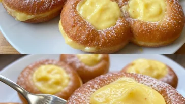 Ein leckerer Sahnekrapfen mit Sahnefüllung auf einem Teller.