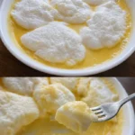 Schneenockerl in cremiger Vanillesauce serviert auf einem Teller.