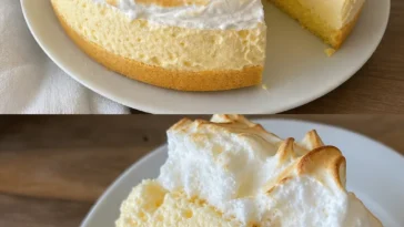 Zitronen-Baiser-Kuchen auf einem Teller, dekoriert mit frischen Zitronenscheiben.